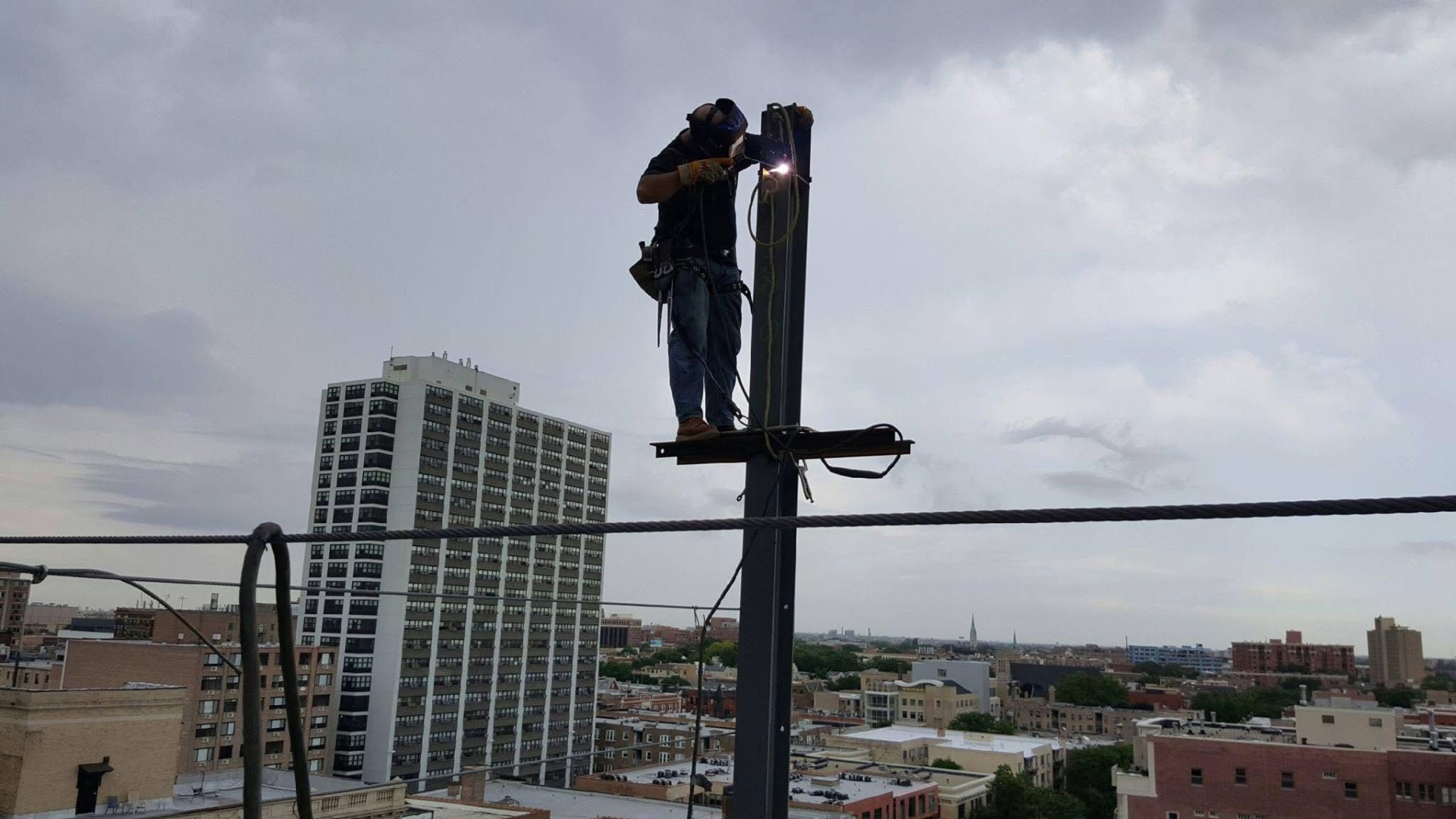 Structural steel erection with crane on an active construction site